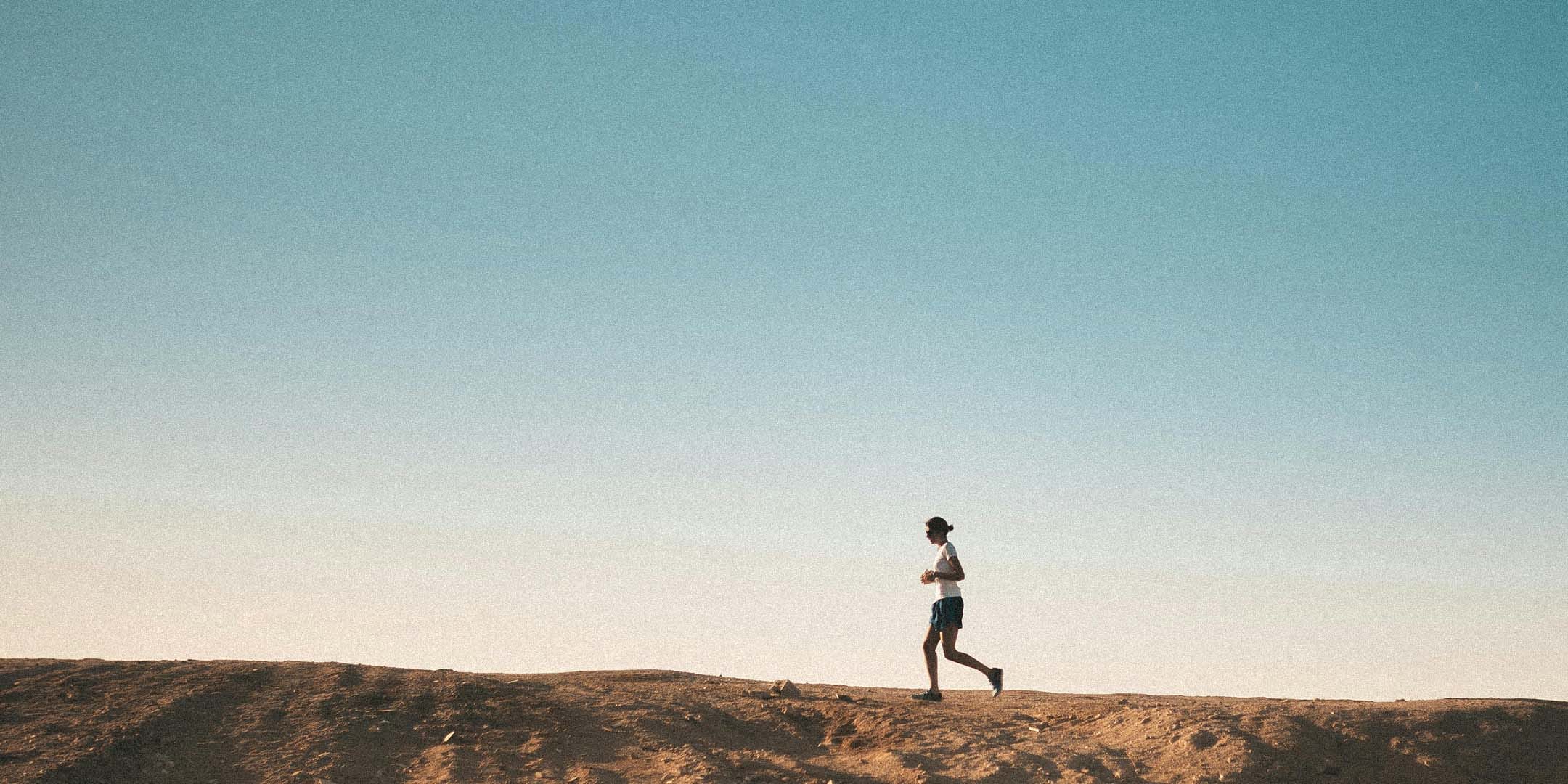 Woman running on a hill